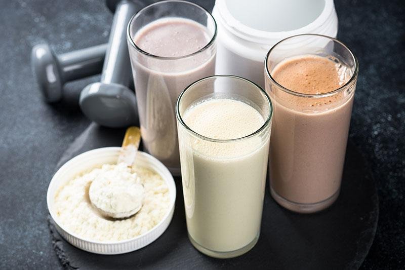 Protein shakes, powder, and dumbbells